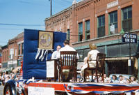 Parade Float with People at Desk and Two Chairs in 1949 Grinnell Day Parade