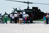 People Gathered Around a Black Helicopter