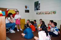 Group Seated on Floor Listening to Girl