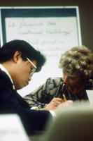 Man and Woman Looking at Notes