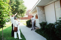 Three People Outside Grinnell Medical Associates Building