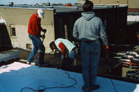Three Men Working on the Roof
