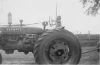 Karen Petersen on a Farmall Tractor
